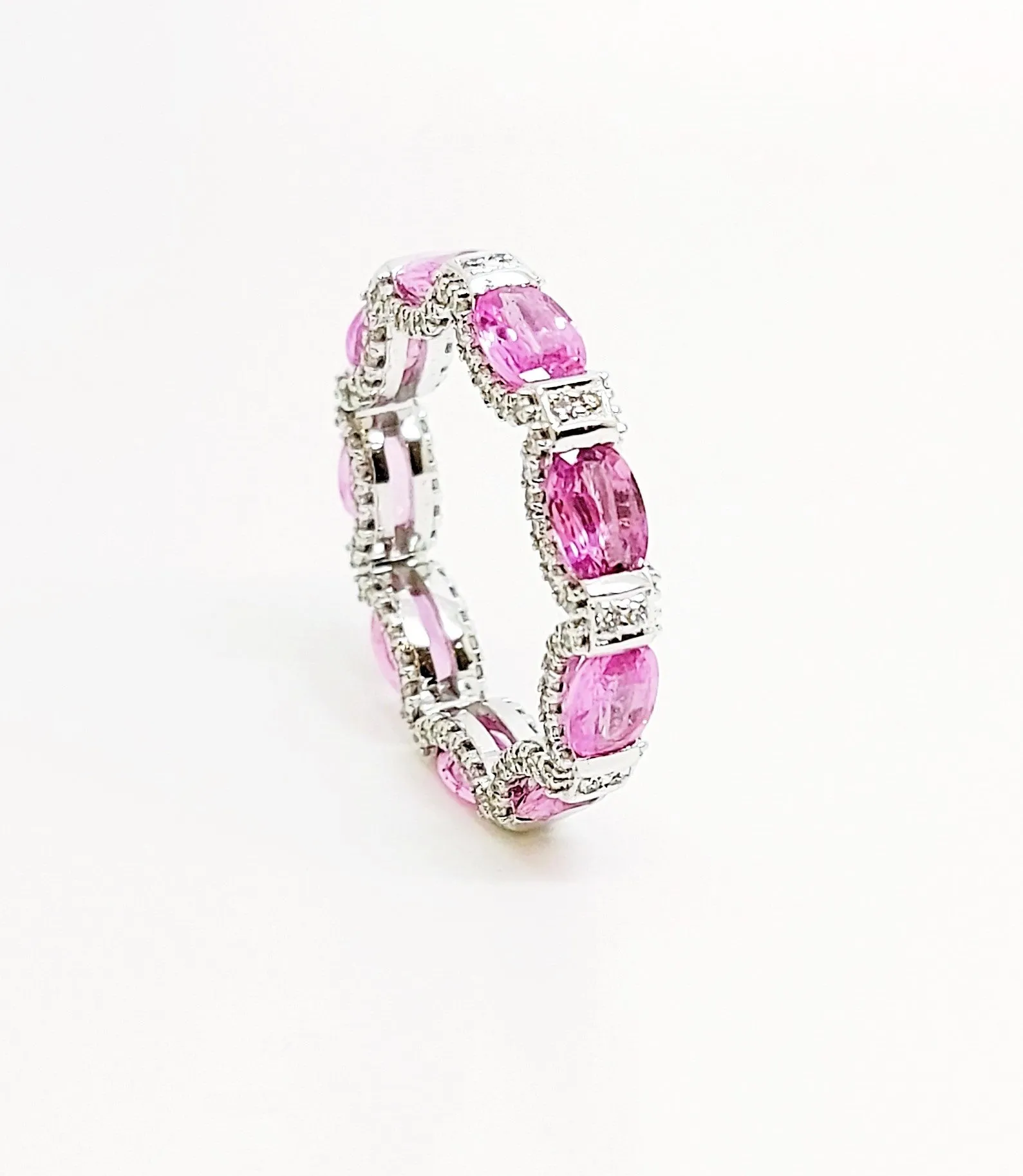 Pink sapphire and diamond hidden halo eternity band